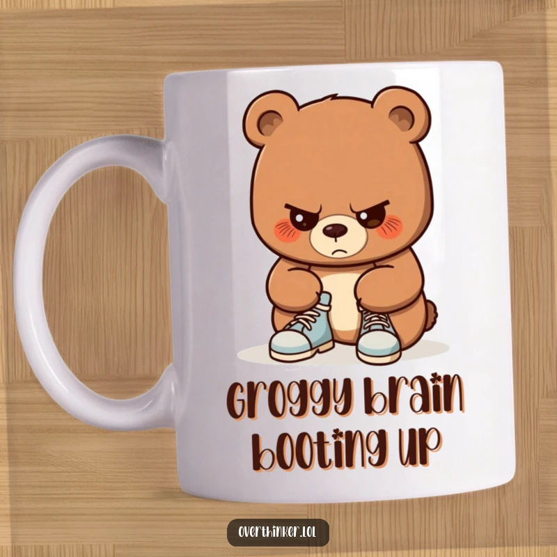 Funny mug showing a bear with intense concentration, fumbling to tie its shoelaces. Captures the humor of simple tasks done with great effort.