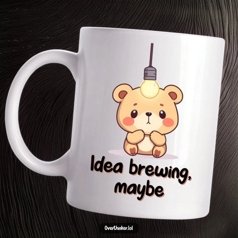 Funny bear mug showing a thoughtful bear staring intensely at a single, blinking lightbulb, symbolizing ideas and contemplation.