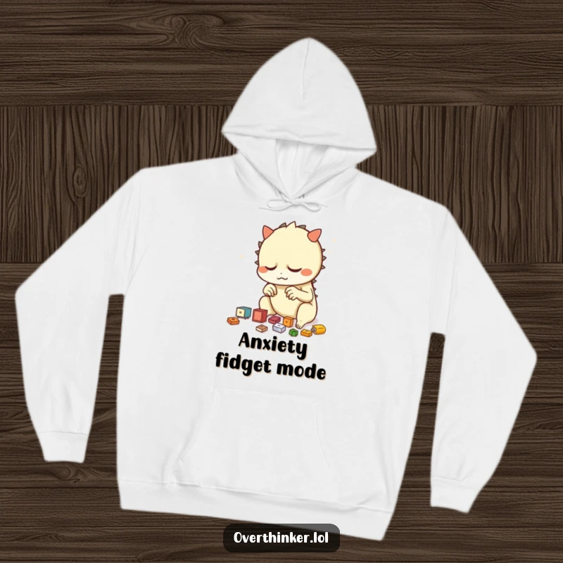 Funny hoodie illustration of a creature nervously arranging small objects repeatedly, representing a charmingly anxious personality.