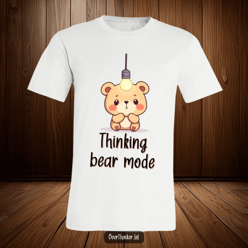 Funny bear t-shirt featuring a focused bear intently observing a single, blinking lightbulb, representing inspiration and thought.