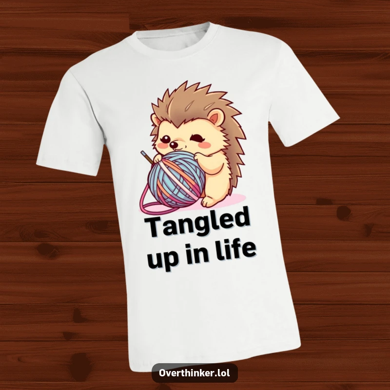 Funny Kawaii hedgehog t-shirt depicting a flustered character hopelessly tangled in a ball of yarn, ideal for crafters and humor lovers.